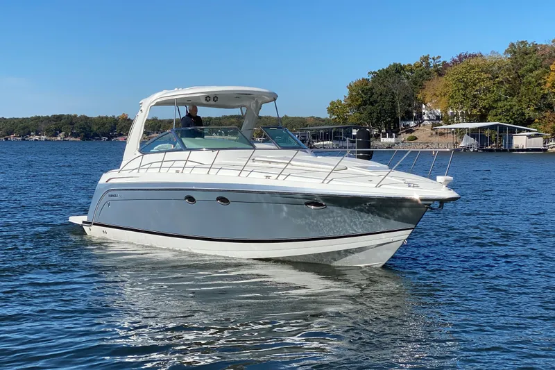 Slide: The Image of 2005 Formula 40 Performance Cruiser on a serene lake with autumn trees in the background. - 2
