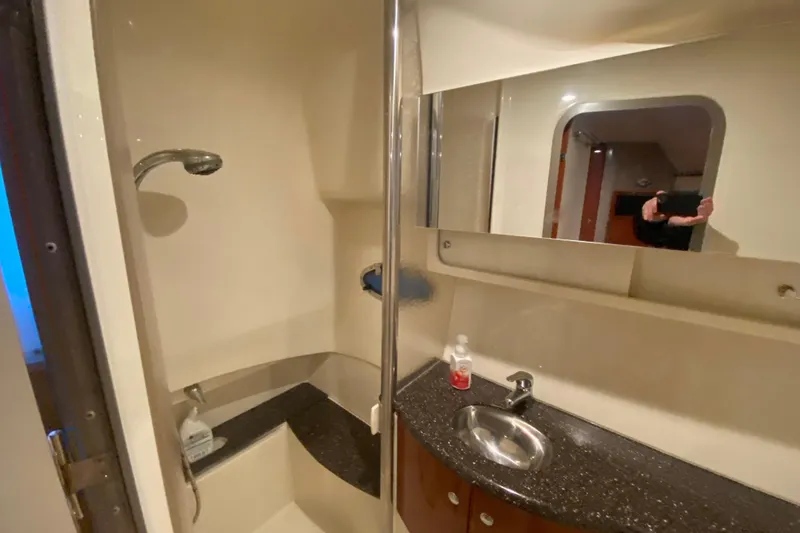 Slide: The Image of Covered 2005 Formula 40 Performance Cruiser docked by a lakeside. - 44