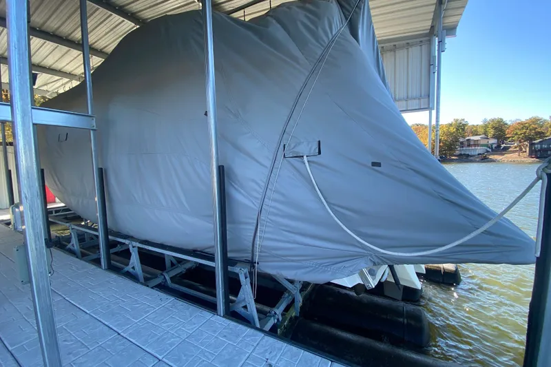 Slide: The Image of 2005 Formula 40 Performance Cruiser docked by a serene lake. - 45
