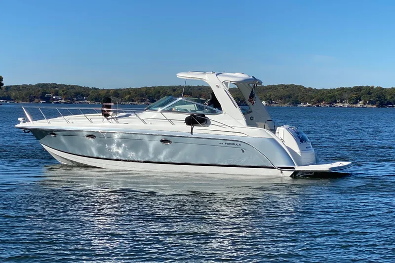 Slide: The Image of 2005 Formula 40 Performance Cruiser, "Bella Sophia," on a lake with autumn trees in the background. - 8