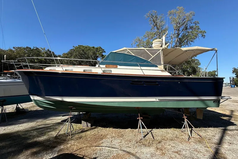 The Image of 1999 Sabre 36 Express boat on stands, outdoors under clear sky. - 0