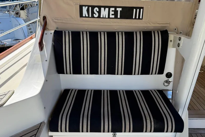 Slide: The Image of Striped seating on 1999 Sabre 36 Express boat, labeled "Kismet III." - 12