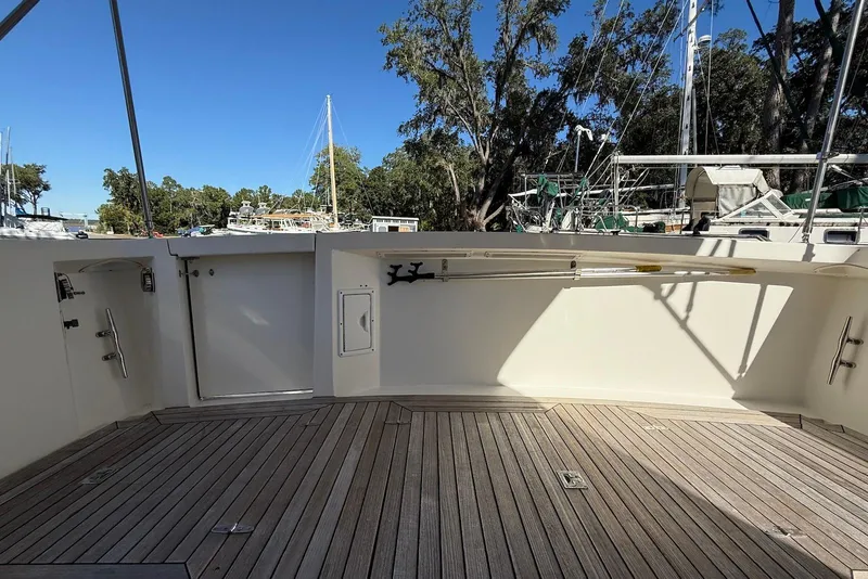 Slide: The Image of 1999 Sabre 36 Express boat deck with wooden flooring and marina view. - 13
