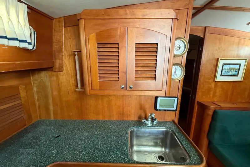 Slide: The Image of Interior of 1999 Sabre 36 Express yacht with wooden cabinetry and sink. - 23