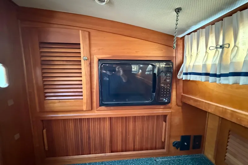 Slide: The Image of 1999 Sabre 36 Express interior with microwave and wooden cabinetry. - 25