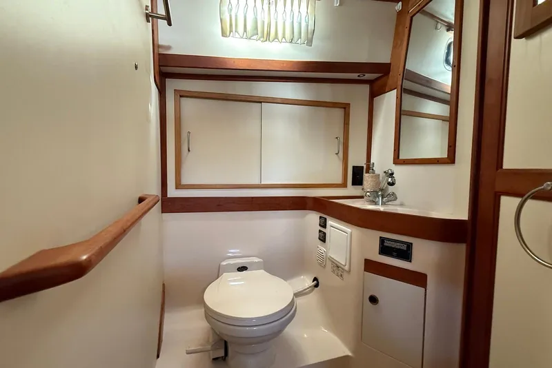 Slide: The Image of 1999 Sabre 36 Express yacht bathroom with wooden accents and modern fixtures. - 27