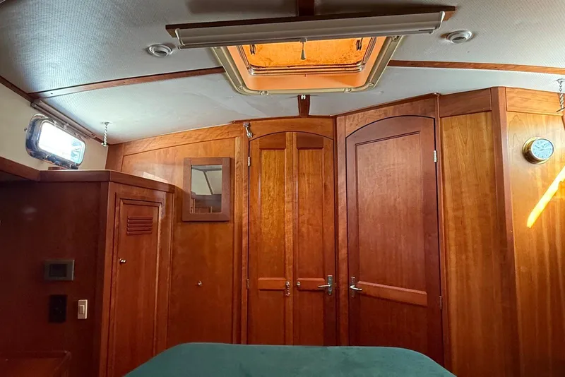 Slide: The Image of Interior of 1999 Sabre 36 Express yacht with wooden cabinetry and ceiling hatch. - 28