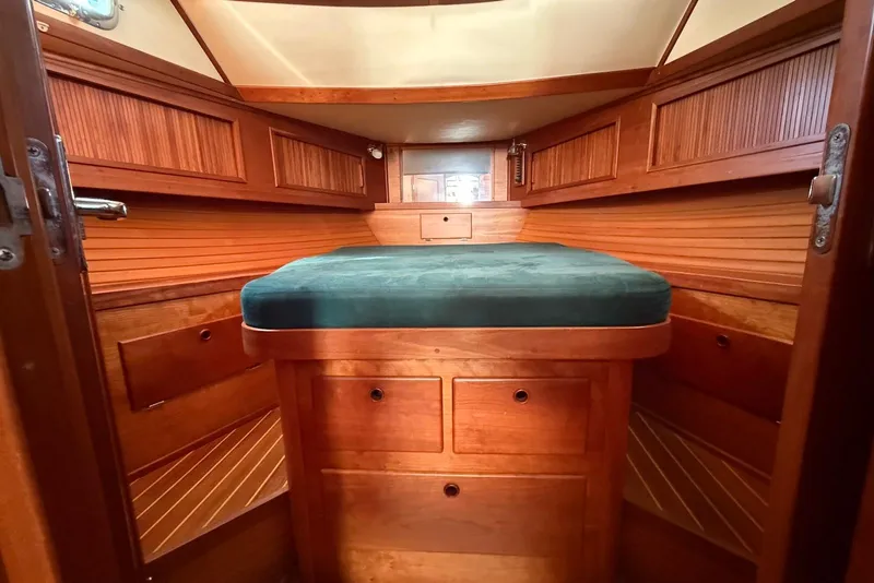 Slide: The Image of Cozy cabin interior of 1999 Sabre 36 Express with wooden finish and green bedding. - 30