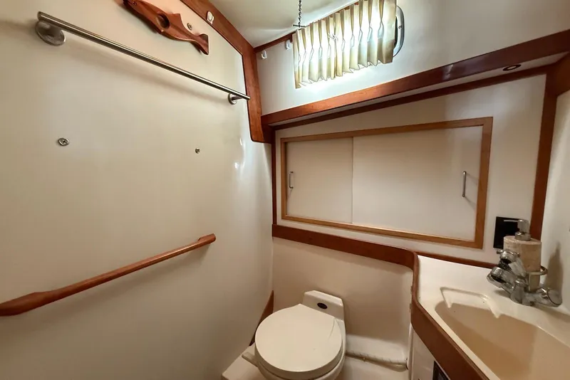 Slide: The Image of 1999 Sabre 36 Express yacht bathroom with wooden accents and compact design. - 32