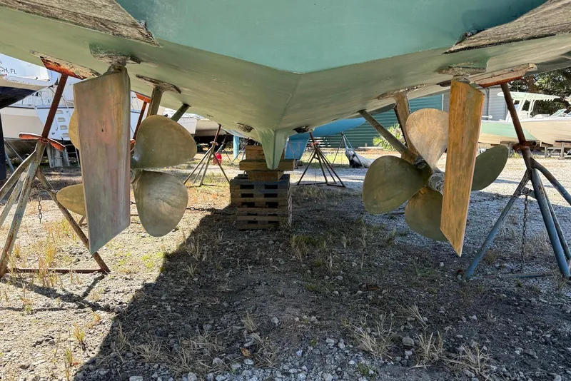 Slide: The Image of 1999 Sabre 36 Express boat underside with propellers and rudders on dry dock. - 38