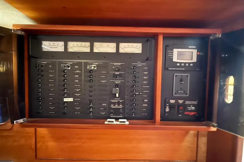 Slide: The Image of Electrical control panel on a 1999 Sabre 36 Express boat, featuring gauges and switches. - 40