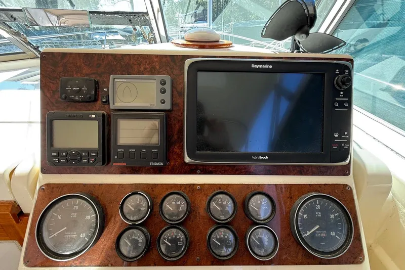 Slide: The Image of 1999 Sabre 36 Express dashboard with navigation and control instruments. - 8