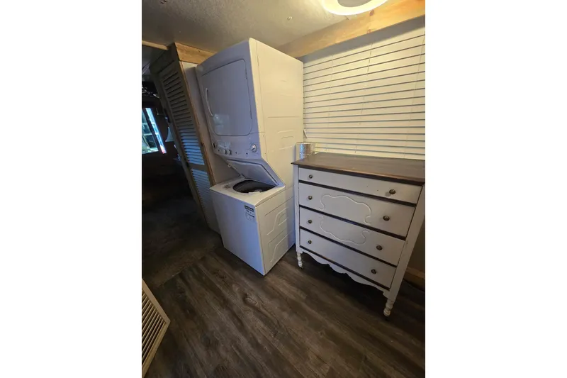 Slide: The Image of Stacked washer and dryer beside vintage dresser in a cozy laundry room. - 12