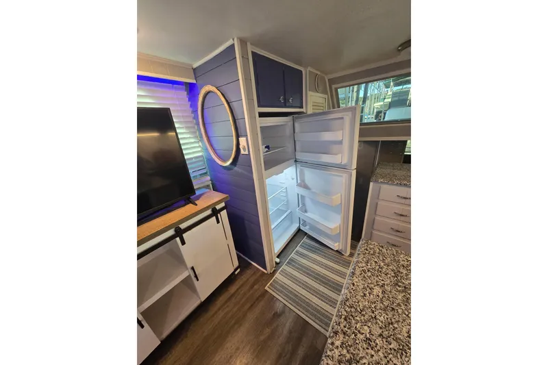 Slide: The Image of Modern kitchen with open refrigerator, granite countertop, and stylish cabinetry, featuring a 1977 Gibson 50 Standard. - 15