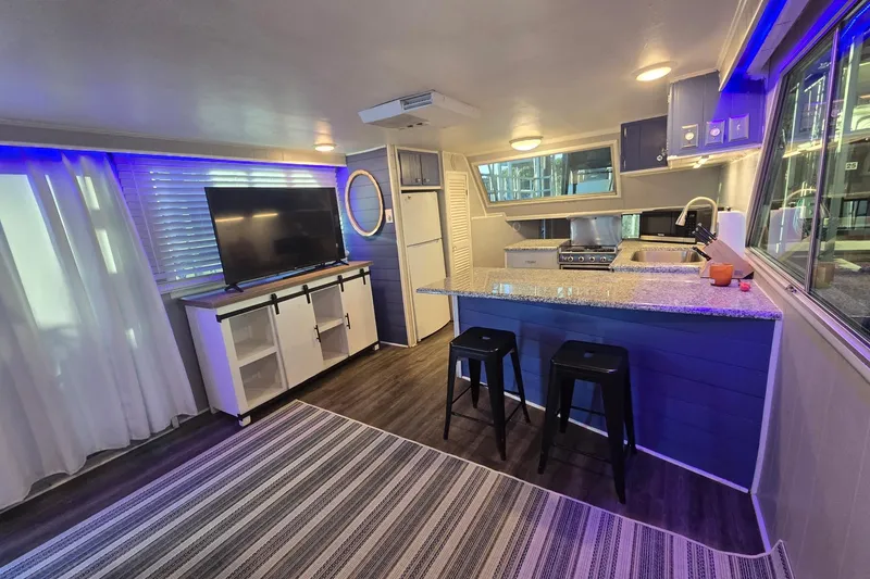 Slide: The Image of Modern interior of a 1977 Gibson 50 Standard houseboat with kitchen and living area. - 17