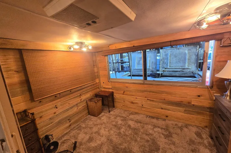 Slide: The Image of Cozy wooden room with carpet, window, and vintage decor, featuring a 1977 Gibson 50 Standard. - 28