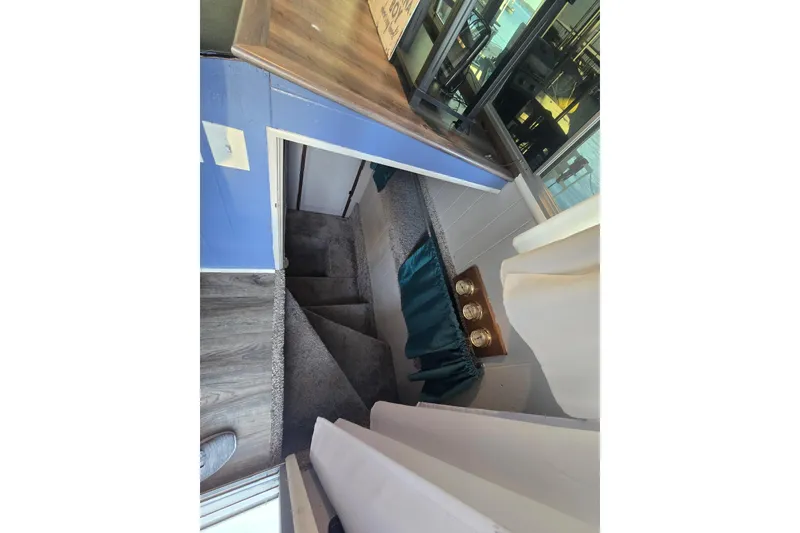 Slide: The Image of Interior view of a 1977 Gibson 50 Standard, featuring a staircase and wooden surfaces. - 29