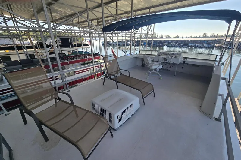 Slide: The Image of 1977 Gibson 50 Standard boat deck with lounge chairs and helm under canopy. - 3