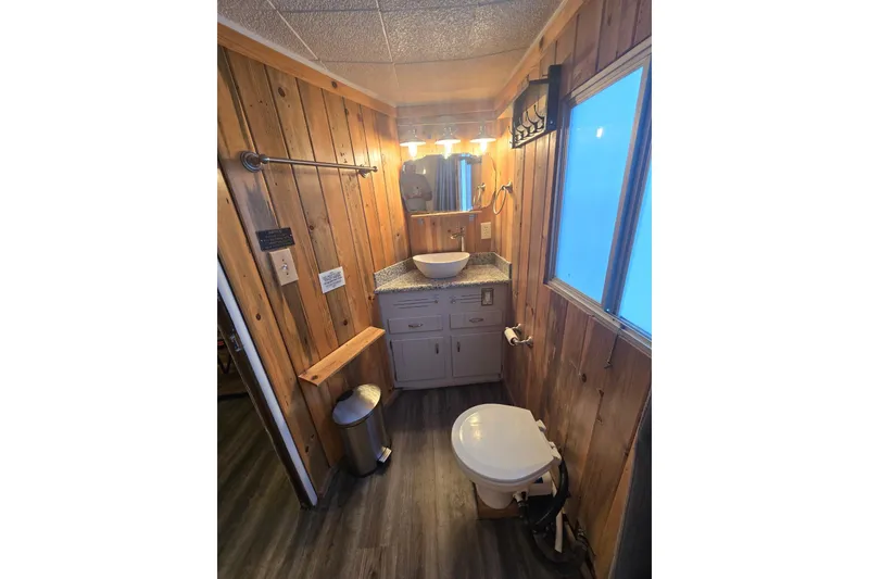 Slide: The Image of Rustic bathroom with wood paneling, vessel sink, and modern lighting. - 8