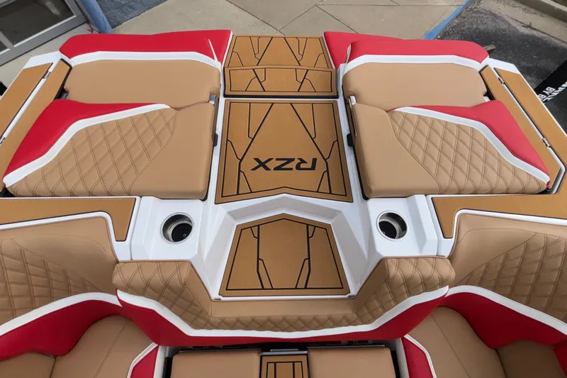 Slide: The Image of 2026 Tigé 24RZX boat interior with tan and red cushioned seating. - 10