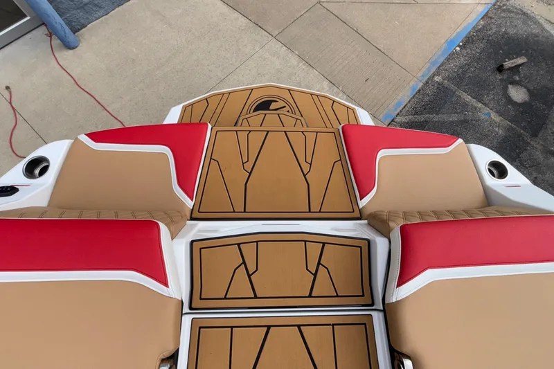 Slide: The Image of 2026 Tigé 24RZX boat interior with red and tan seating and custom flooring. - 11