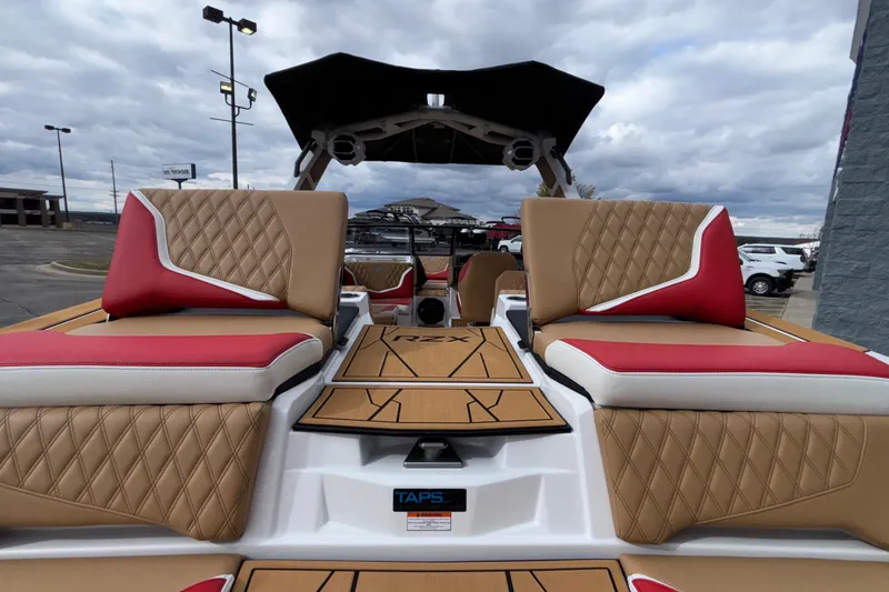 Slide: The Image of 2026 Tigé 24RZX boat interior with tan and red seating, outdoor display. - 16