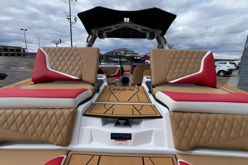 Slide: The Image of 2026 Tigé 24RZX boat interior with tan and red diamond-stitched seating. - 17