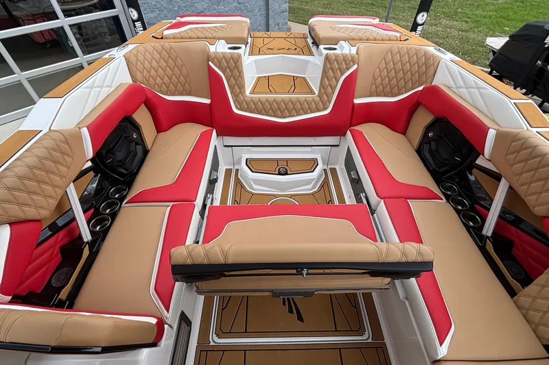 Slide: The Image of Luxurious interior of 2026 Tigé 24RZX boat with red and tan seating. - 23