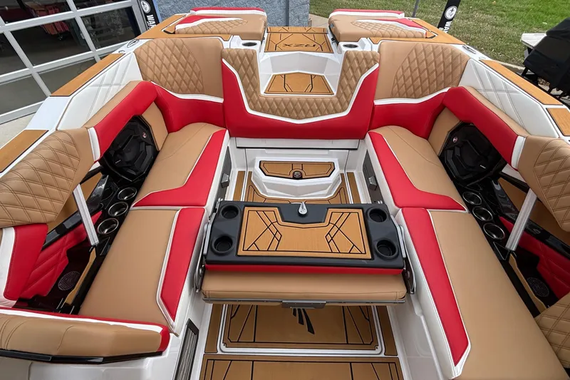 Slide: The Image of Luxurious interior of 2026 Tigé 24RZX boat with red and tan seating. - 24