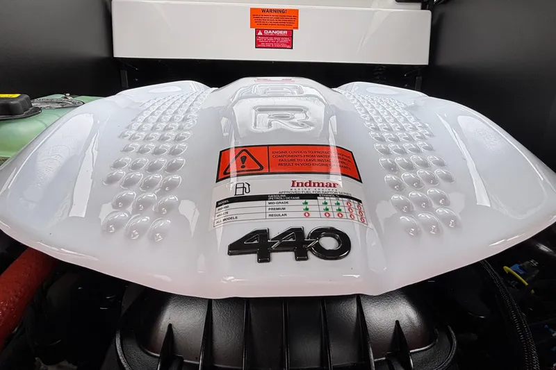Slide: The Image of 2026 Tigé 24RZX engine cover with Indmar 440 branding and safety warnings. - 28