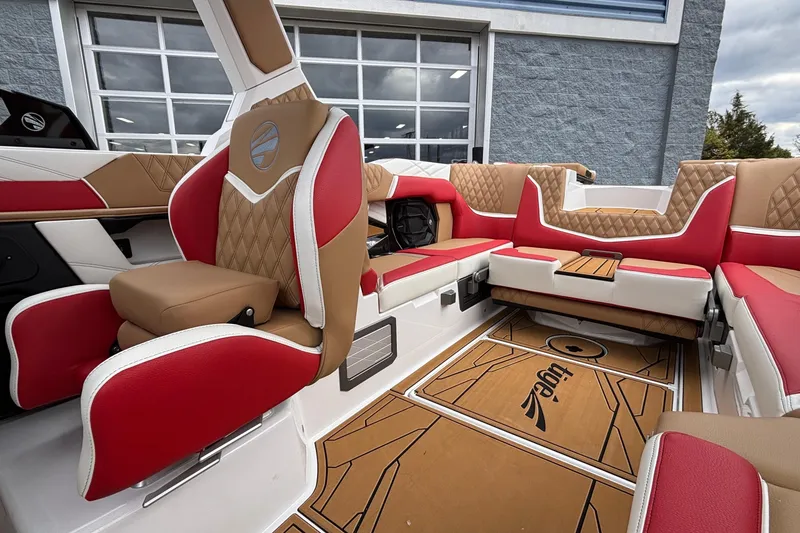 Slide: The Image of Luxurious interior of 2026 Tigé 24RZX boat with red and tan seating. - 31
