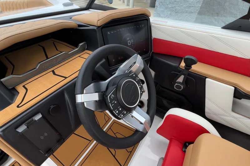 Slide: The Image of 2026 Tigé 24RZX boat interior with modern steering wheel and dashboard controls. - 32