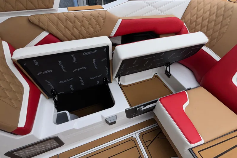 Slide: The Image of 2026 Tigé 24RZX boat interior with open storage compartments and stylish seating. - 35