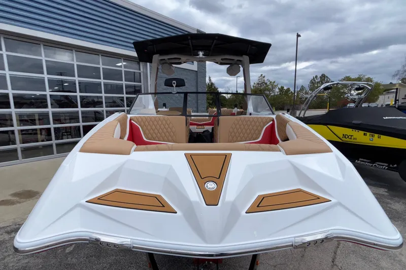 Slide: The Image of 2026 Tigé 24RZX boat with tan and red interior, parked outdoors. - 4