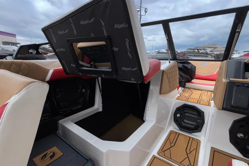 Slide: The Image of 2026 Tigé 24RZX boat interior with open storage compartment and stylish seating. - 43