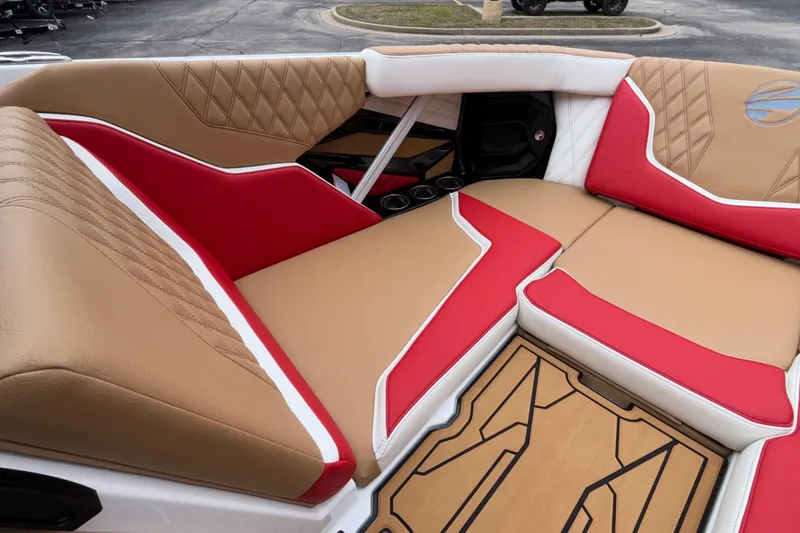 Slide: The Image of 2026 Tigé 24RZX boat interior with tan and red cushioned seating. - 46