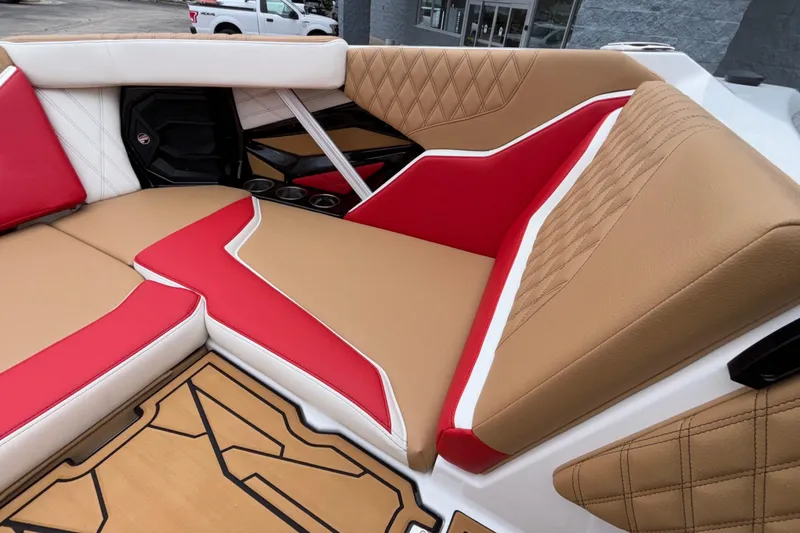 Slide: The Image of 2026 Tigé 24RZX boat interior with red and tan upholstery, featuring quilted patterns. - 48