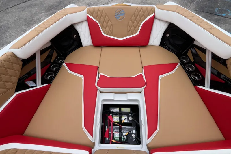 Slide: The Image of 2026 Tigé 24RZX boat interior with red and tan seating, open battery compartment. - 50