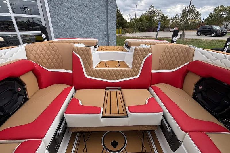 Slide: The Image of 2026 Tigé 24RZX boat interior with red and tan quilted seating. - 7