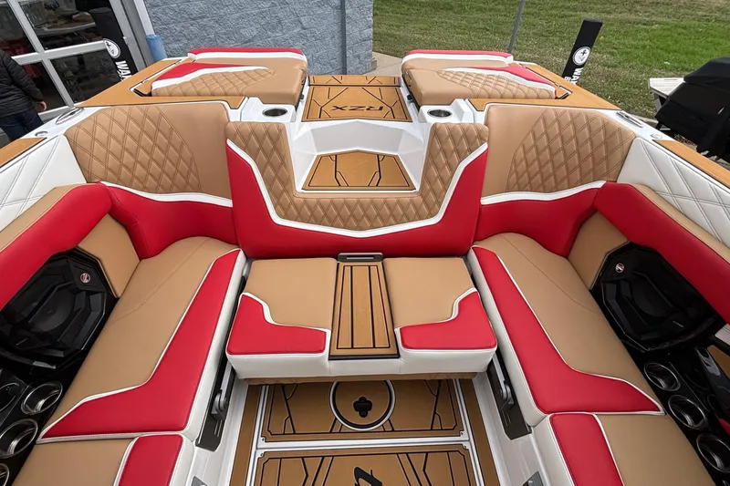 Slide: The Image of Luxurious interior of 2026 Tigé 24RZX boat with red and tan seating. - 8