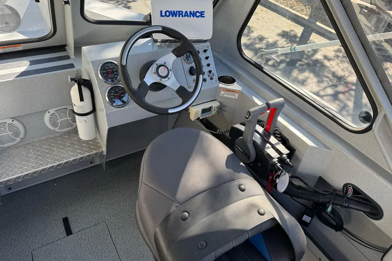 Slide: The Image of 2017 Duckworth 20 Advantage boat cockpit with steering wheel, gauges, and Lowrance equipment. - 10
