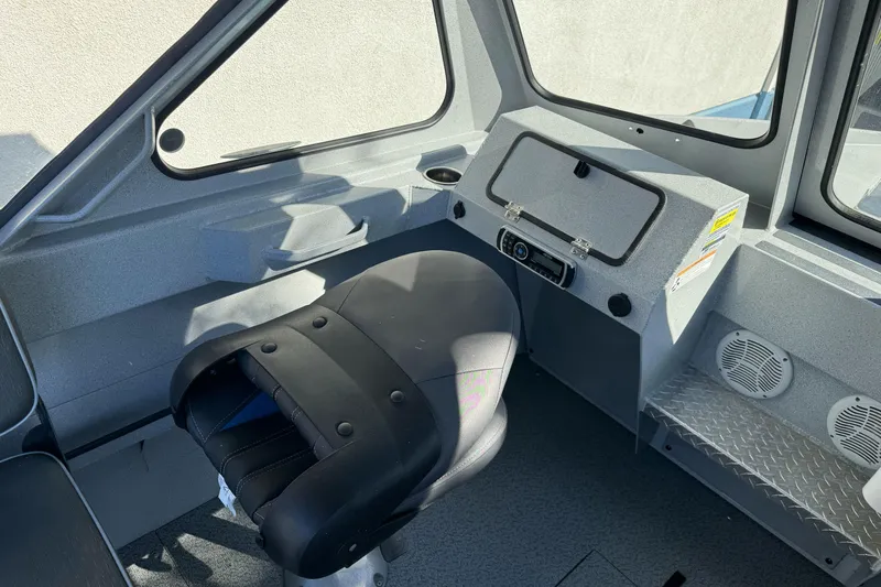 Slide: The Image of Interior of a 2017 Duckworth 20 Advantage boat, featuring a captain's seat and control panel. - 11