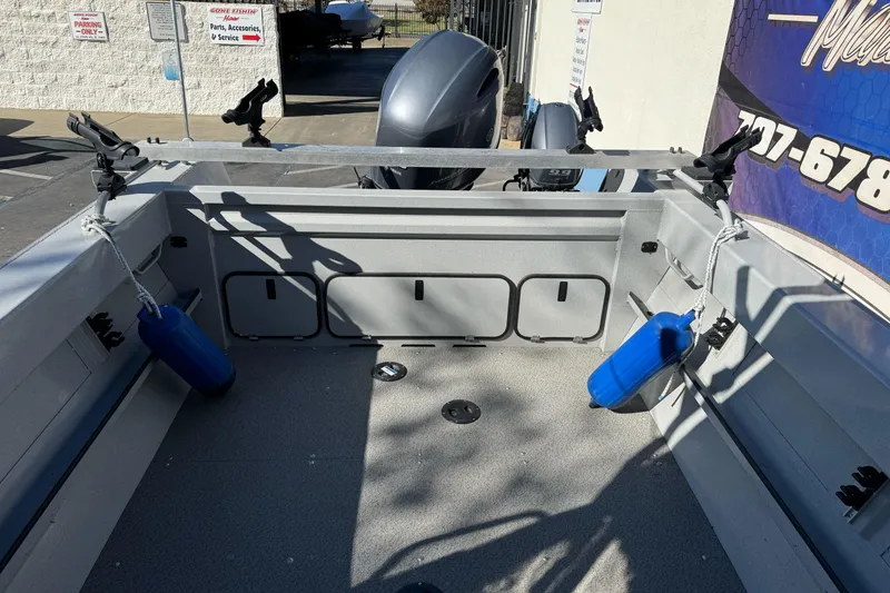 Slide: The Image of 2017 Duckworth 20 Advantage boat interior with rod holders and blue fenders. - 9