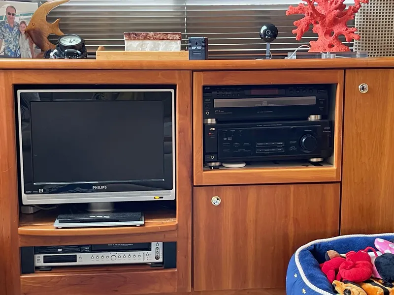 Slide: The Image of 2002 Silverton 392 Motor Yacht interior with TV, stereo, and wooden cabinetry. - 10