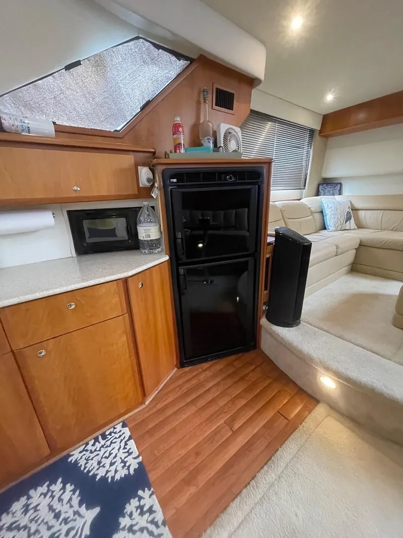 Slide: The Image of Interior of a 2002 Silverton 392 Motor Yacht with kitchenette and seating area. - 12