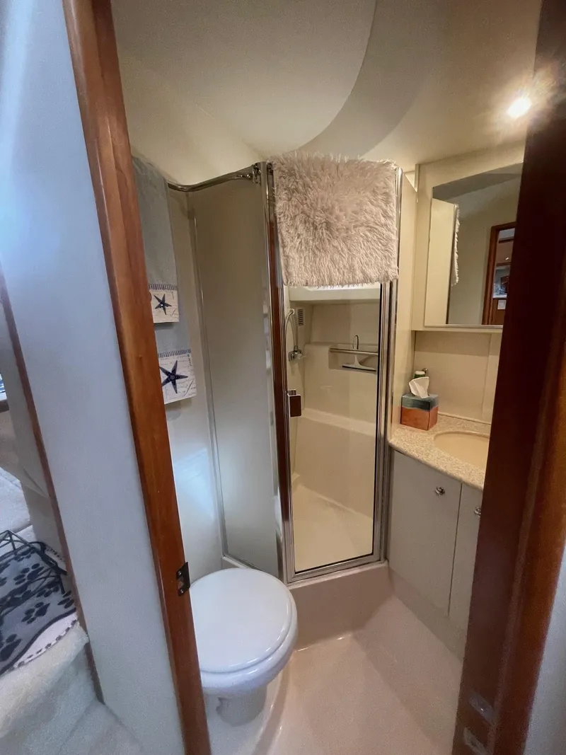 Slide: The Image of 2002 Silverton 392 Motor Yacht bathroom with shower, toilet, and sink. - 13