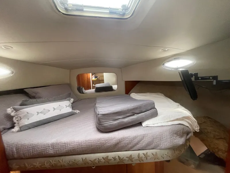 Slide: The Image of Cozy cabin interior of 2002 Silverton 392 Motor Yacht with bed and porthole window. - 15