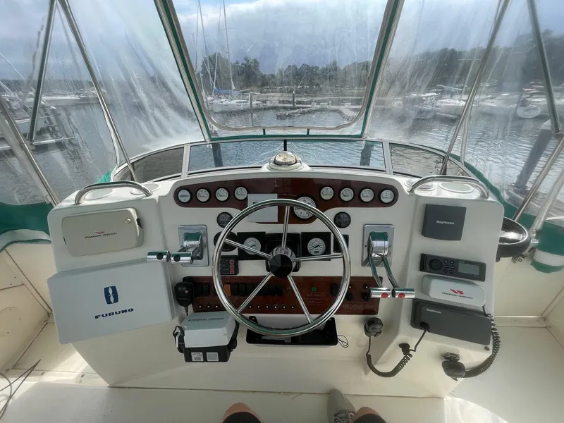 Slide: The Image of Helm of 2002 Silverton 392 Motor Yacht with steering wheel and control panel. - 18