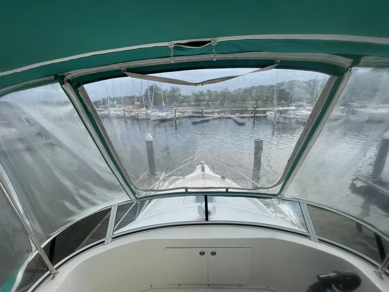 Slide: The Image of View from 2002 Silverton 392 Motor Yacht cockpit, overlooking marina with clear canopy. - 19