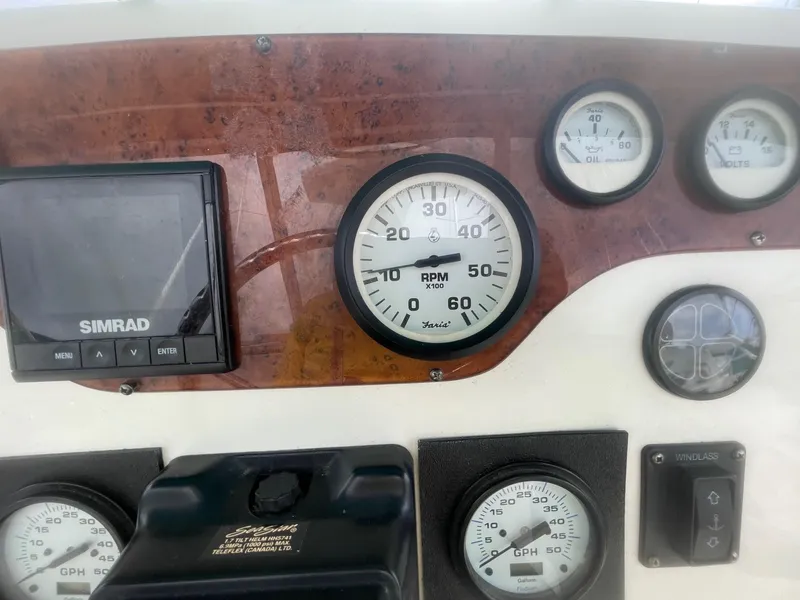 Slide: The Image of Dashboard of a 2002 Silverton 392 Motor Yacht with gauges and Simrad display. - 21
